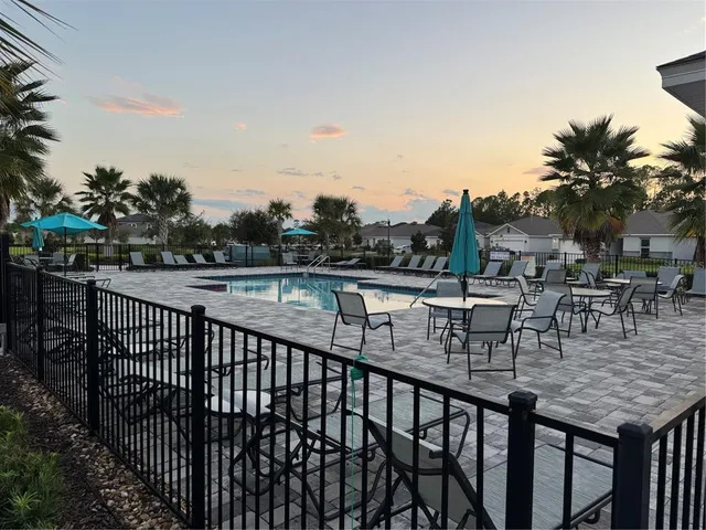 a kitchen with a sink a microwave and cabinets