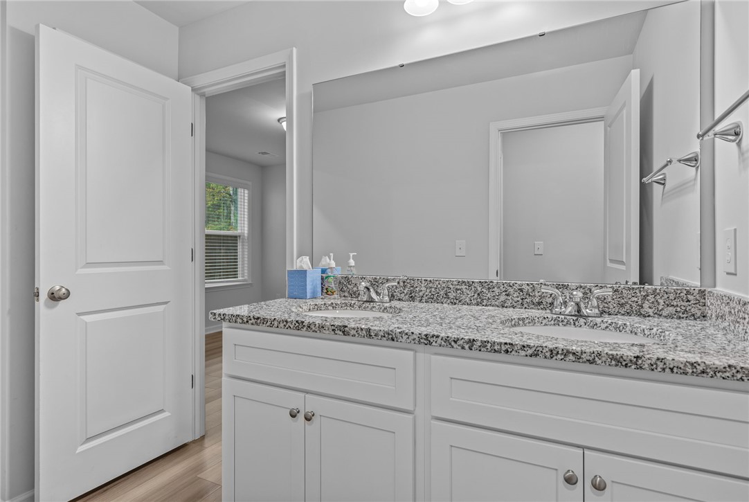24 Chalet Court Anderson, SC 29621 - Photo 25 of 39 This primary bathroom offers a dual vanity with granite counters and durable flooring.