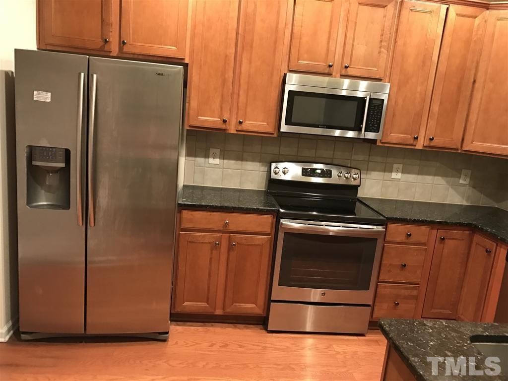 5010 Celtic Court Raleigh, NC 27612 - Photo 11 of 20 a kitchen with stainless steel appliances granite countertop a refrigerator microwave and sink
