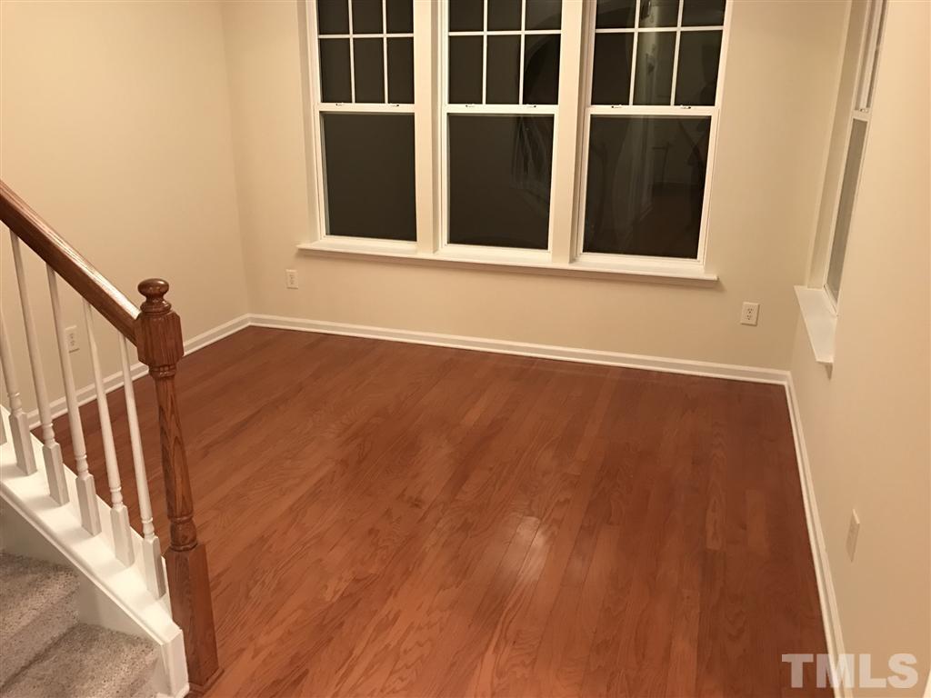 5010 Celtic Court Raleigh, NC 27612 - Photo 13 of 20 a view of an empty room with wooden floor and a window
