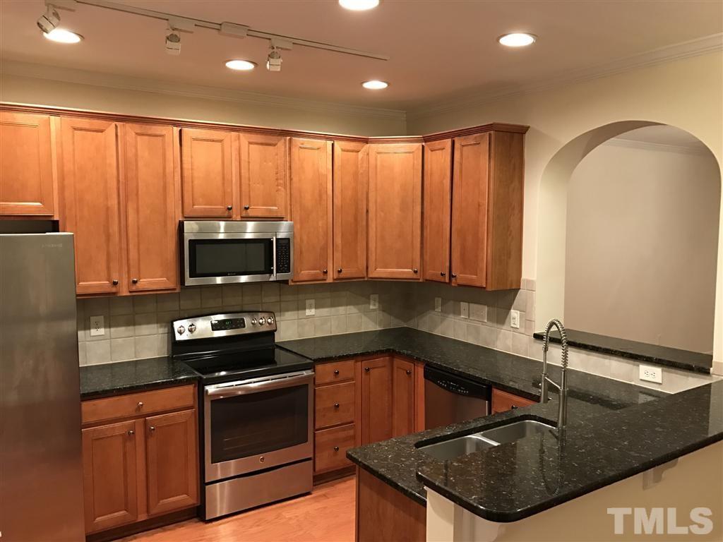 5010 Celtic Court Raleigh, NC 27612 - Photo 14 of 20 a kitchen with stainless steel appliances granite countertop a sink a stove and cabinets