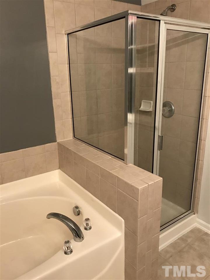 5010 Celtic Court Raleigh, NC 27612 - Photo 20 of 20 a bathroom with a bathtub and a shower