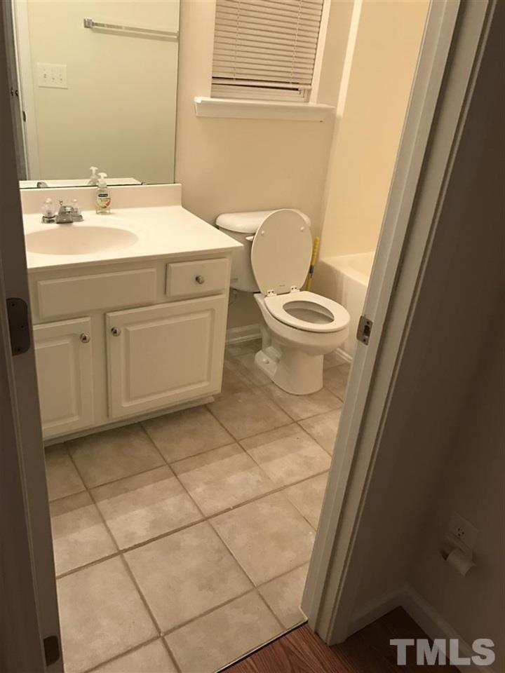 5010 Celtic Court Raleigh, NC 27612 - Photo 6 of 20 a bathroom with a sink toilet and vanity