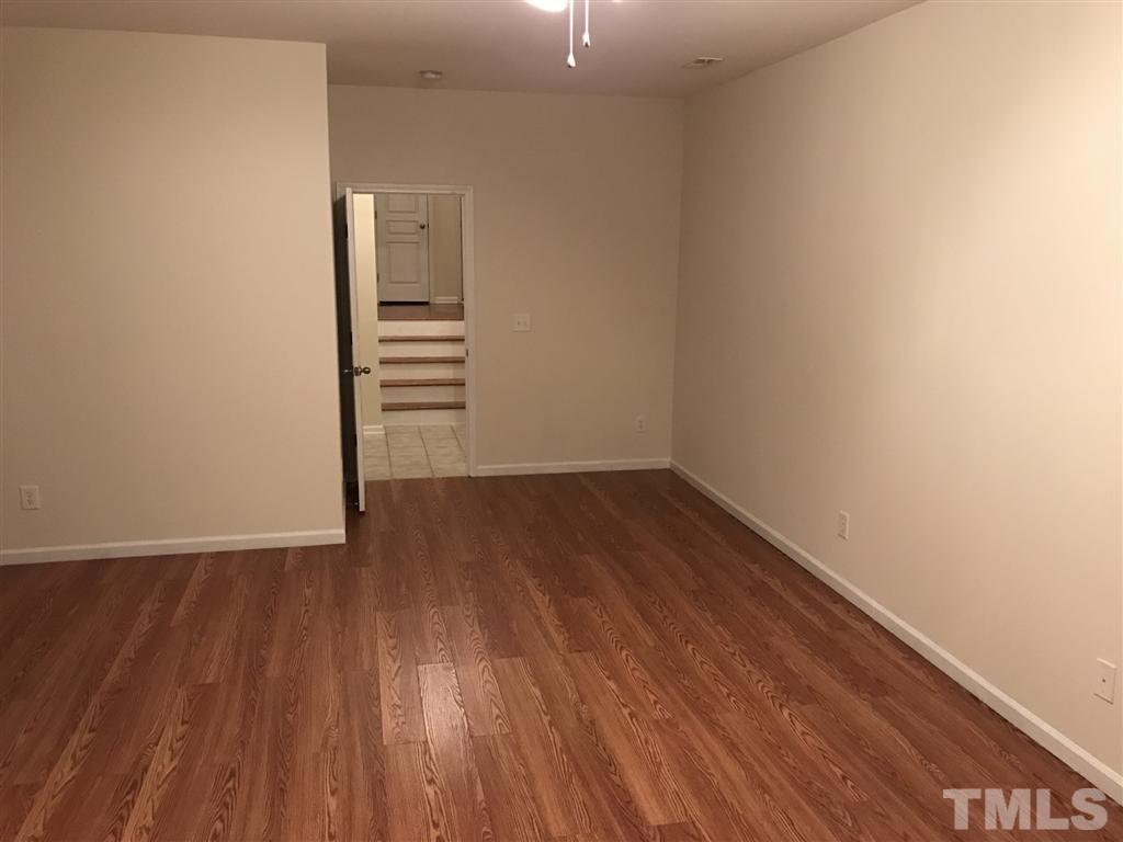 5010 Celtic Court Raleigh, NC 27612 - Photo 7 of 20 a view of a room with wooden floor and white walls