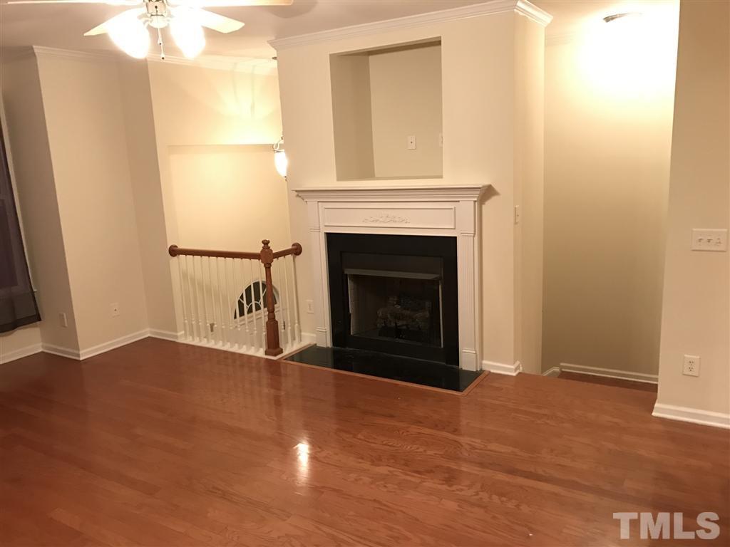 5010 Celtic Court Raleigh, NC 27612 - Photo 9 of 20 a view of an empty room with wooden floor and a fireplace
