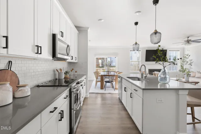a kitchen with stainless steel appliances a sink stove and cabinets