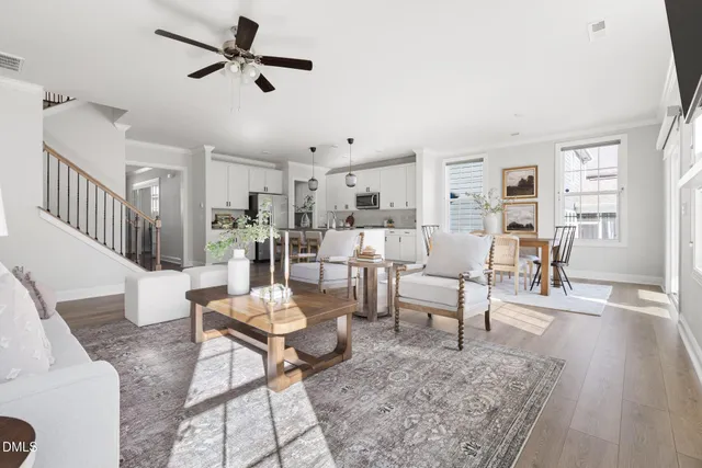 a living room with furniture and a wooden floor
