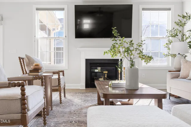 a living room with furniture fireplace and flat screen tv