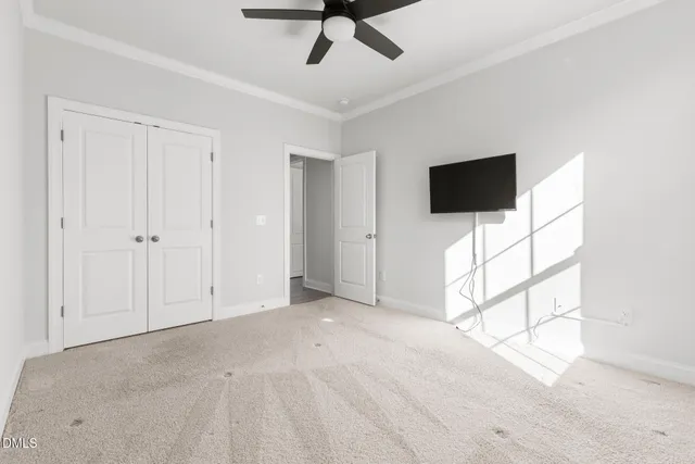 a view of a livingroom with an empty space and a ceiling fan