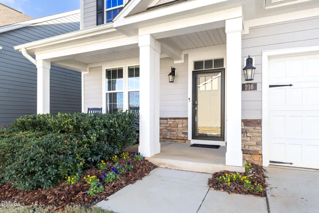 a front view of a house with a garden