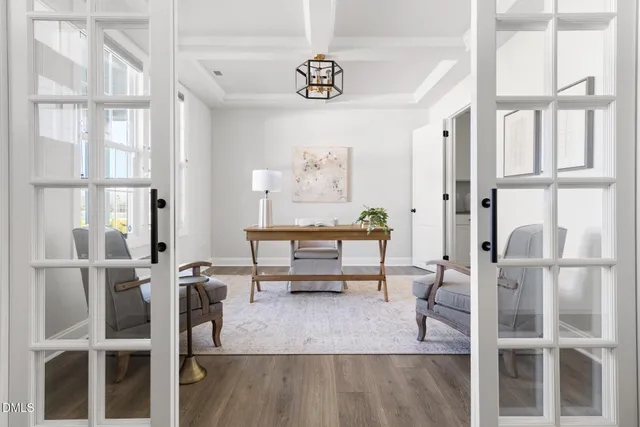 a living room with furniture a dining table and a chandelier