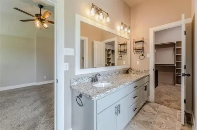 a bathroom with a tub shower and sink