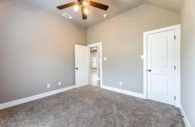 en empty room with fan and entrance