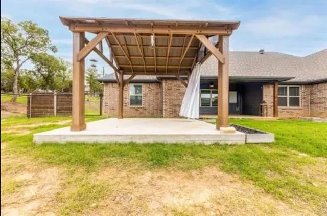 a view of a house with backyard and porch