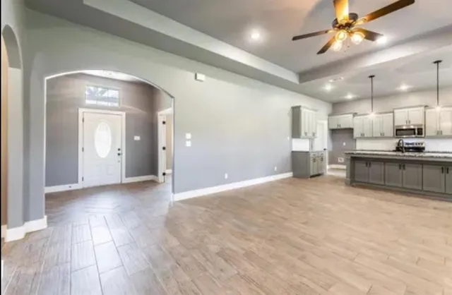 a view of a kitchen with a sink and a refrigerator