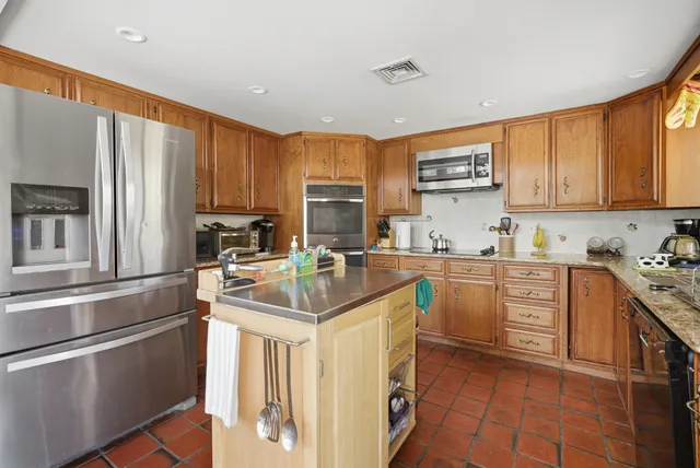 a kitchen with a sink stove and refrigerator
