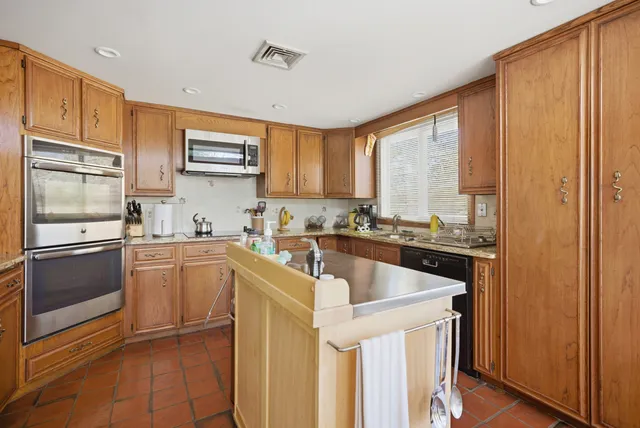 a kitchen with a sink stove and microwave