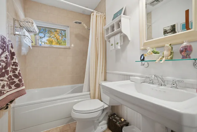 a bathroom with a sink a toilet and a bathtub