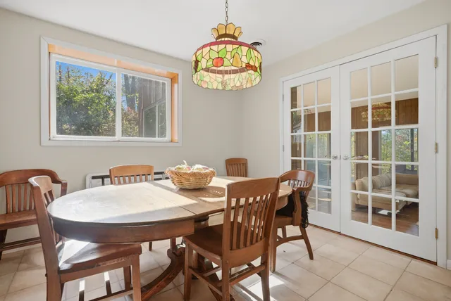 a view of a dining room with furniture and chandelier