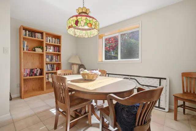 a view of a dining room with furniture and a chandelier