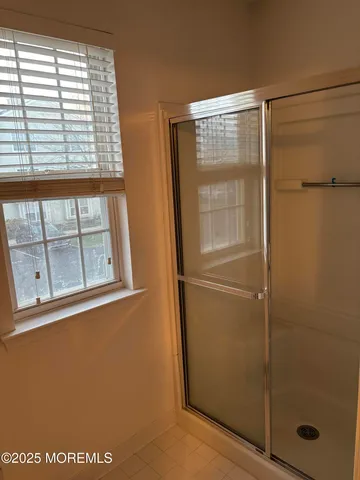 a bathroom with a glass shower door