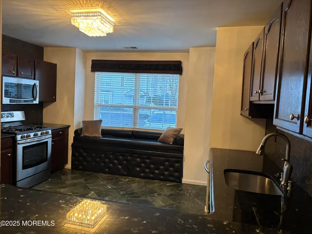 a kitchen with a refrigerator and a stove top oven
