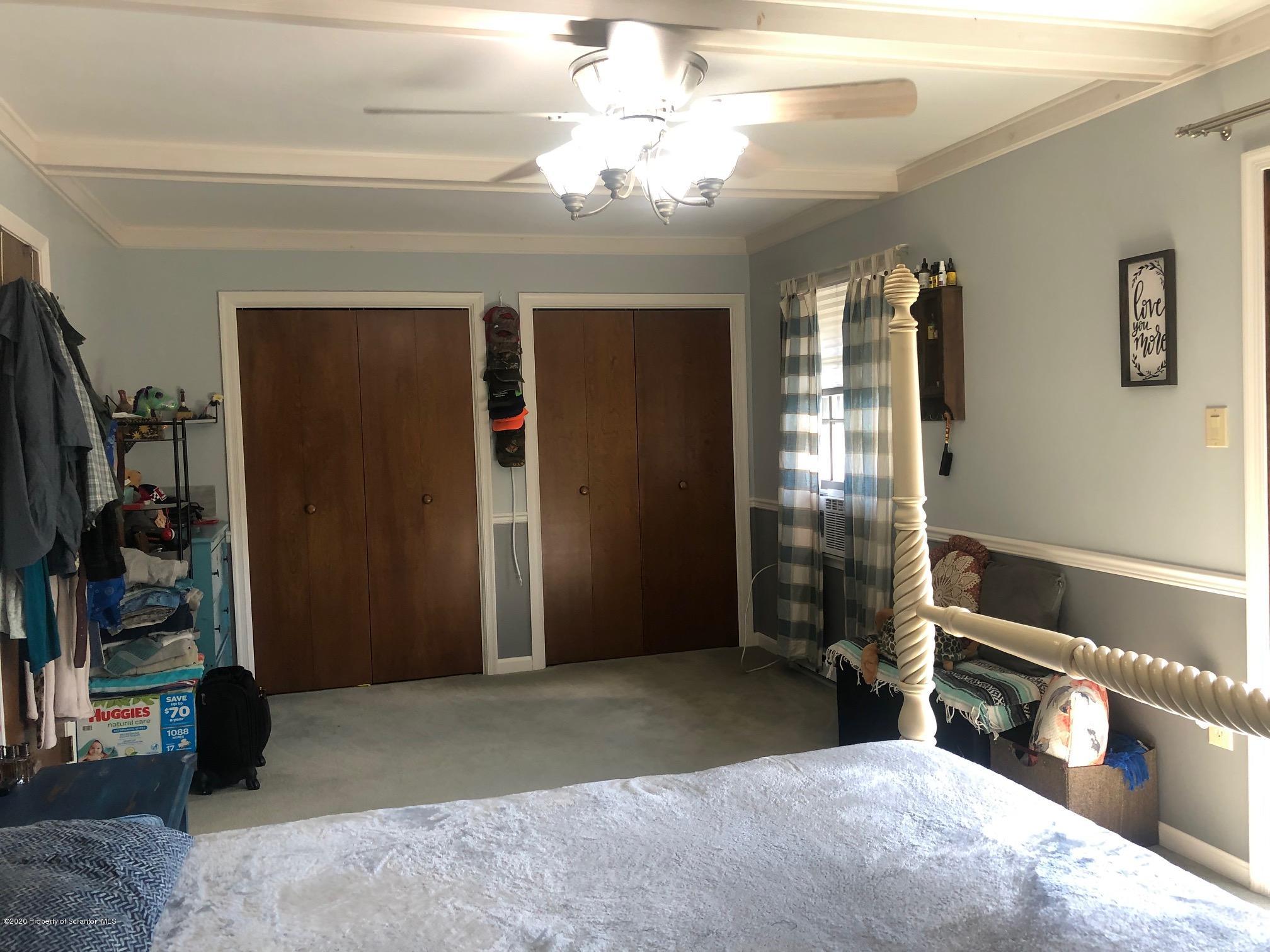 164 Halstead Road Union Dale, PA 18470 - Photo 11 of 36 a bedroom with a bed and a chandelier