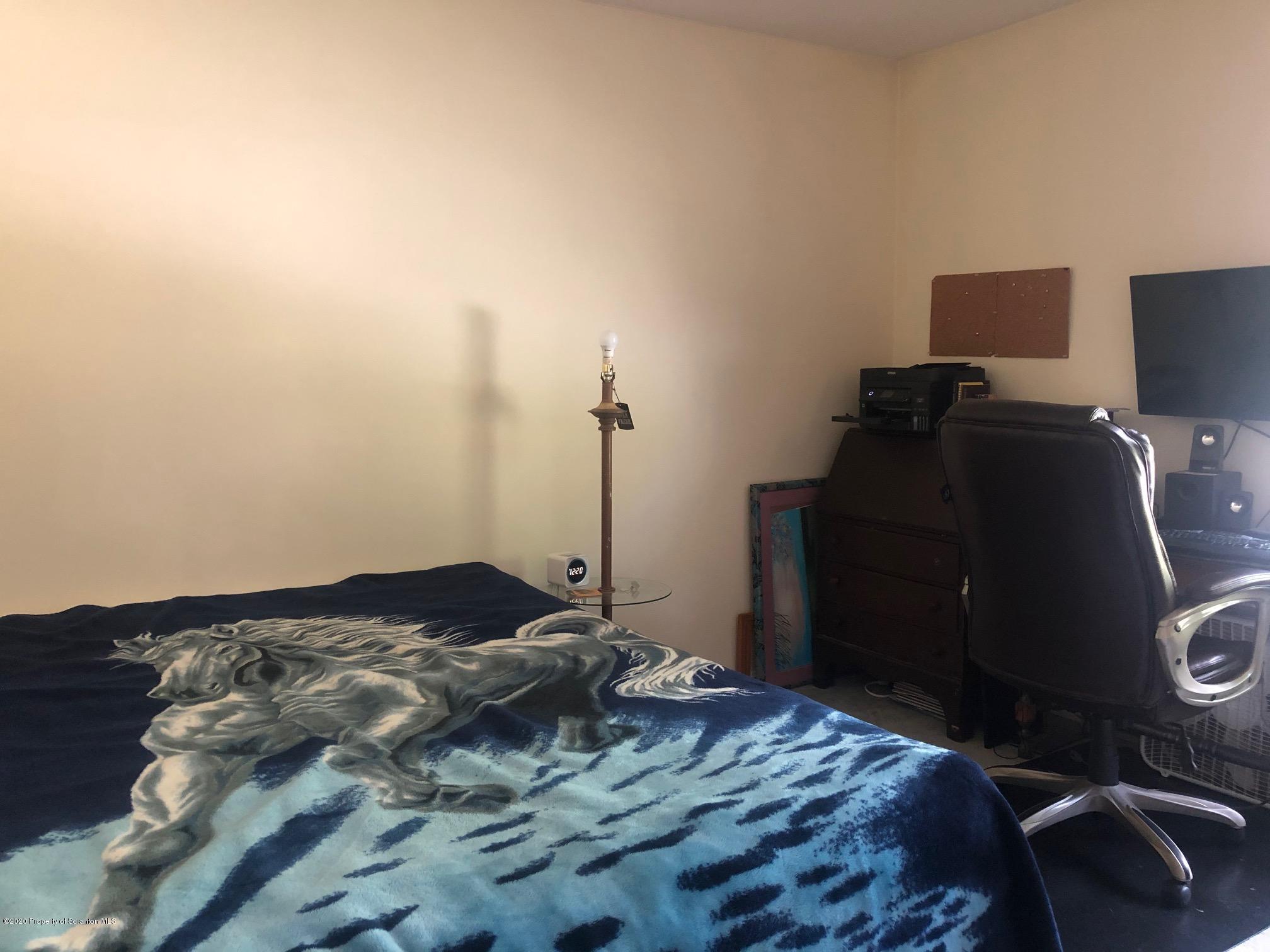 164 Halstead Road Union Dale, PA 18470 - Photo 14 of 36 a bedroom with a bed and a lamp on desk