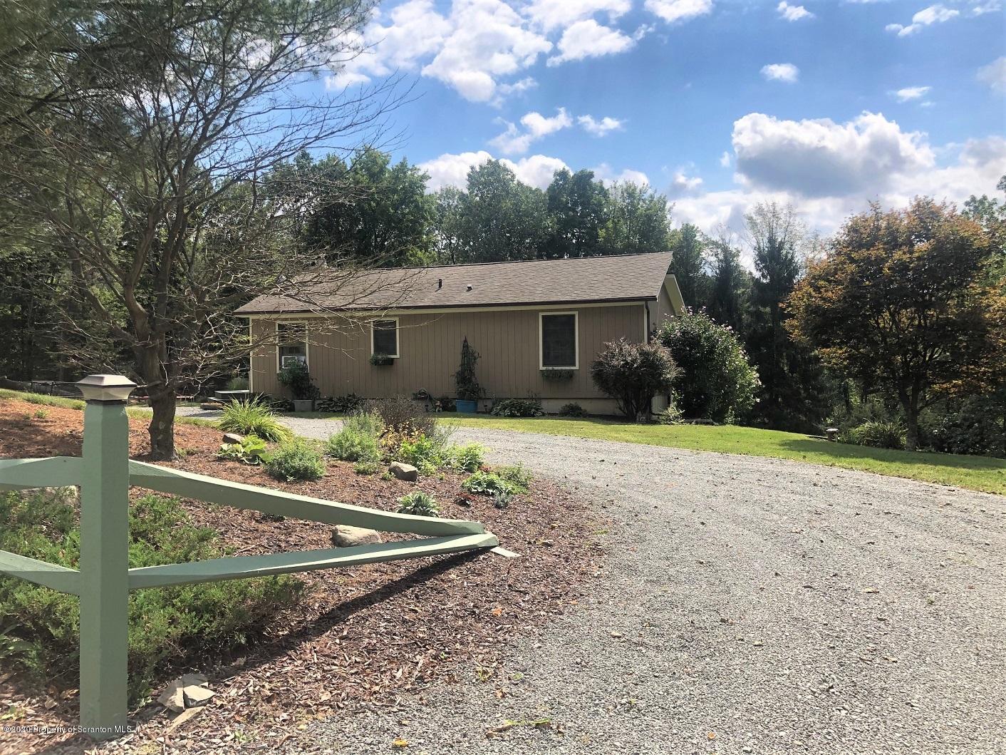 164 Halstead Road Union Dale, PA 18470 - Photo 19 of 36 a view of a house with backyard and trees