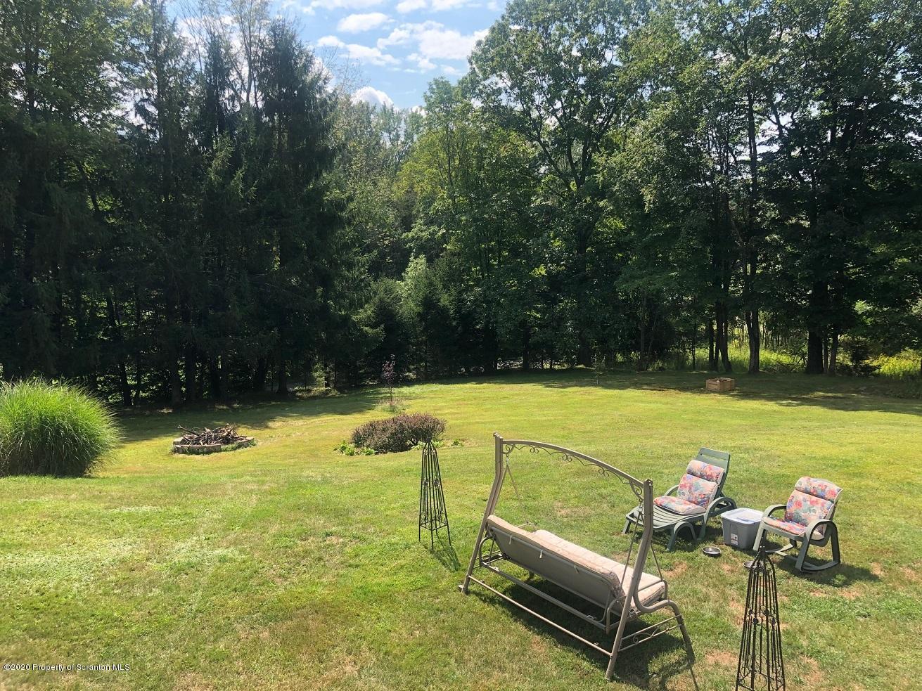 164 Halstead Road Union Dale, PA 18470 - Photo 35 of 36 a swimming pool with outdoor seating and yard