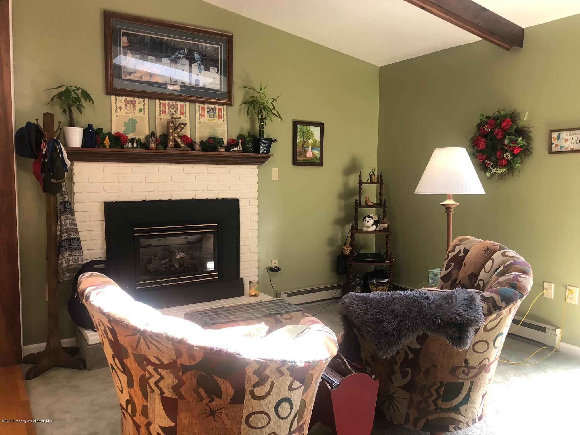 164 Halstead Road Union Dale, PA 18470 - Photo 6 of 36 a living room with furniture and a fireplace