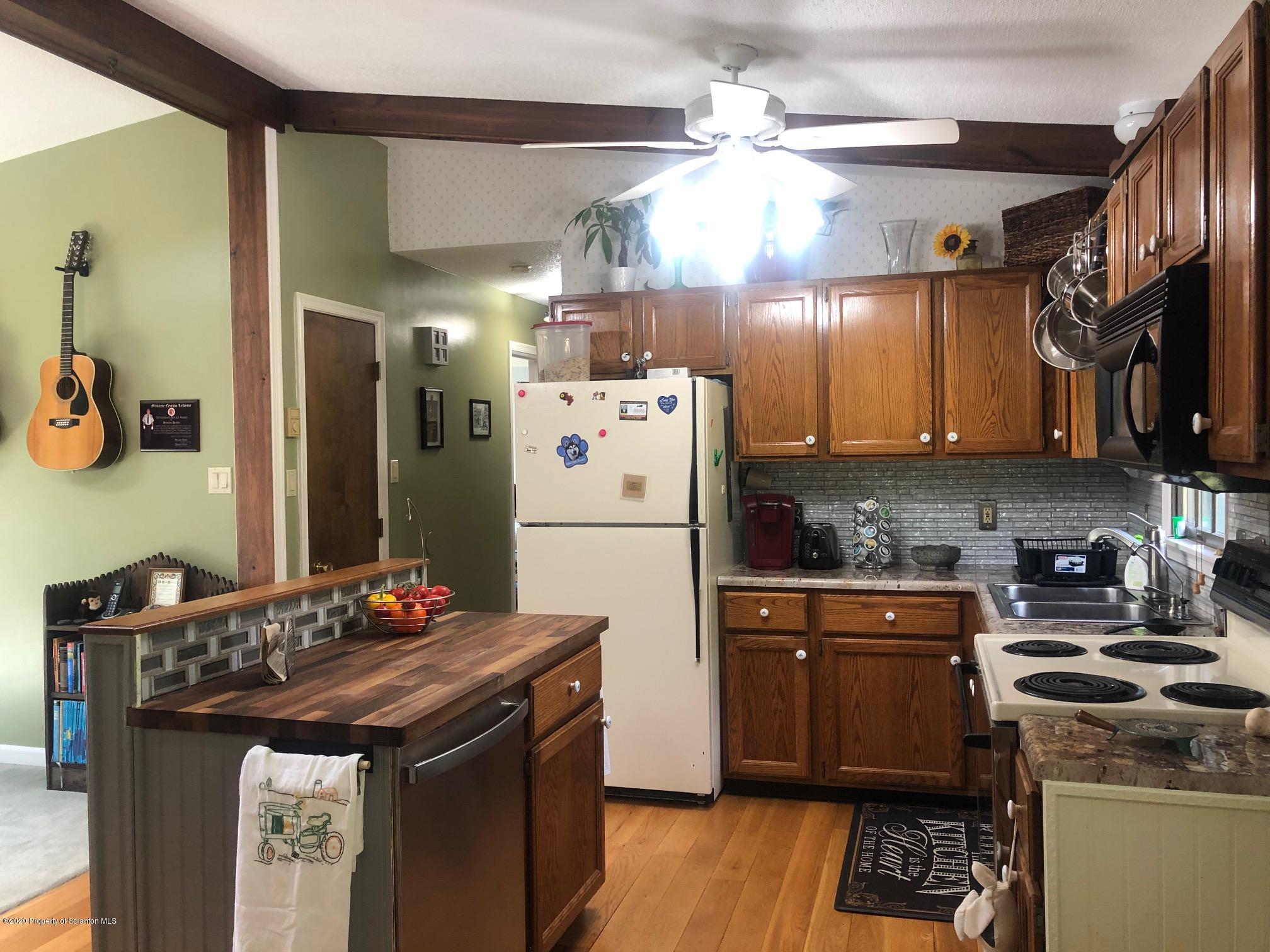 164 Halstead Road Union Dale, PA 18470 - Photo 7 of 36 a kitchen with stainless steel appliances granite countertop a stove a refrigerator and a dining table