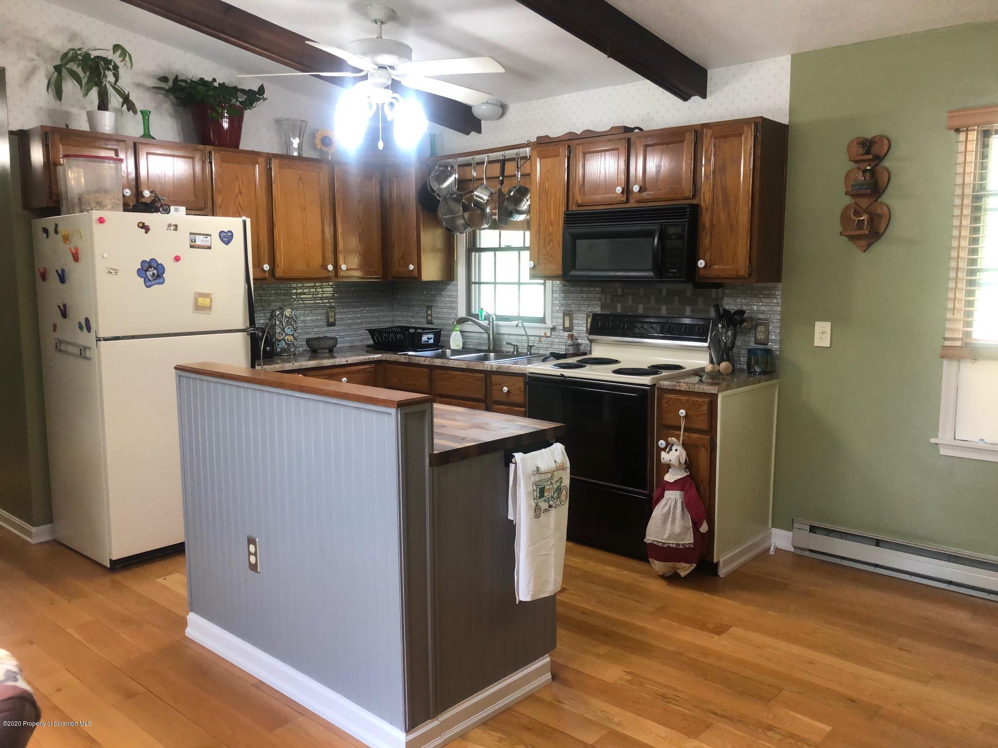 164 Halstead Road Union Dale, PA 18470 - Photo 8 of 36 a kitchen with stainless steel appliances granite countertop a sink stove and refrigerator