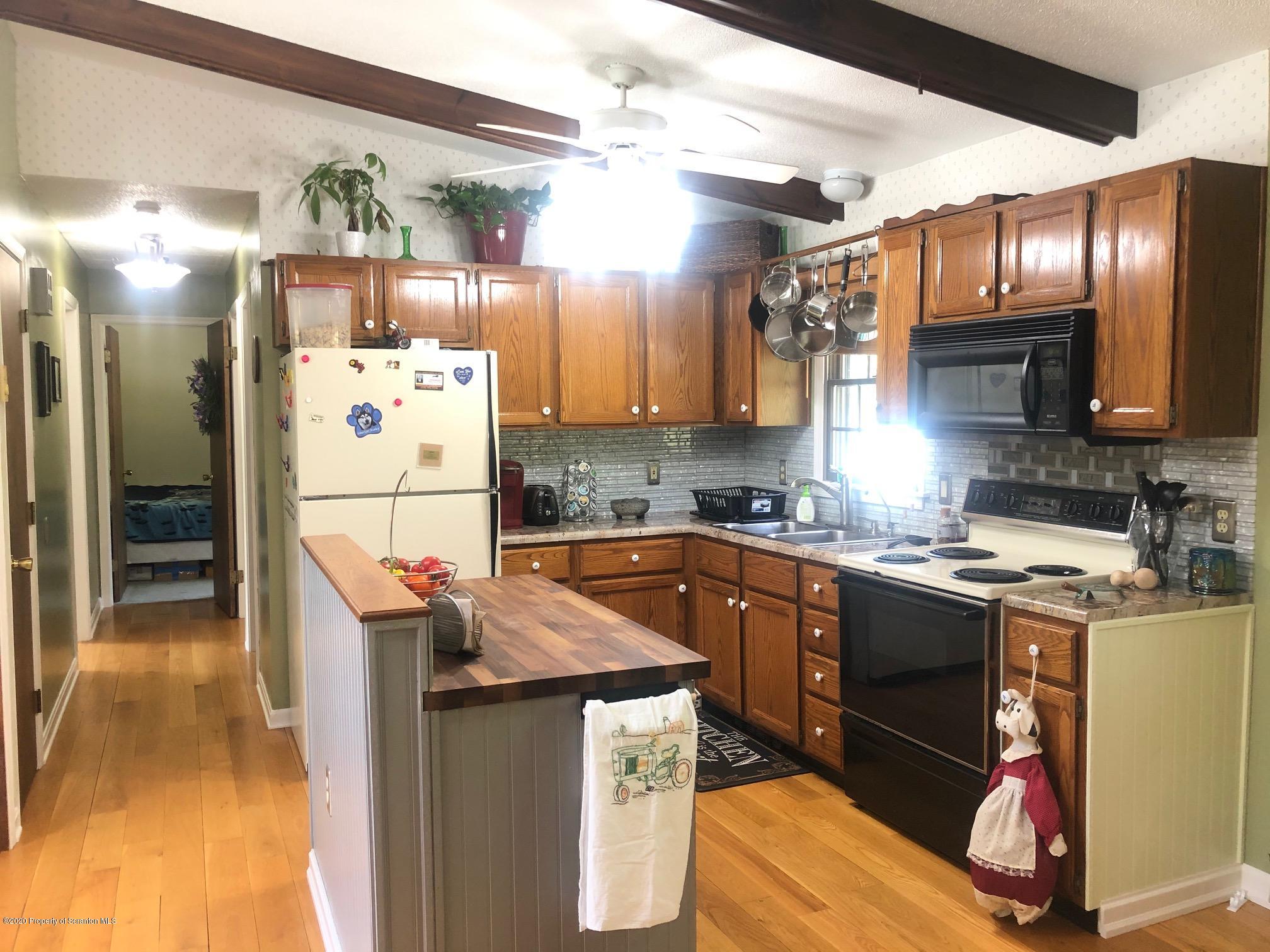 164 Halstead Road Union Dale, PA 18470 - Photo 9 of 36 a kitchen with stainless steel appliances granite countertop a sink stove and refrigerator