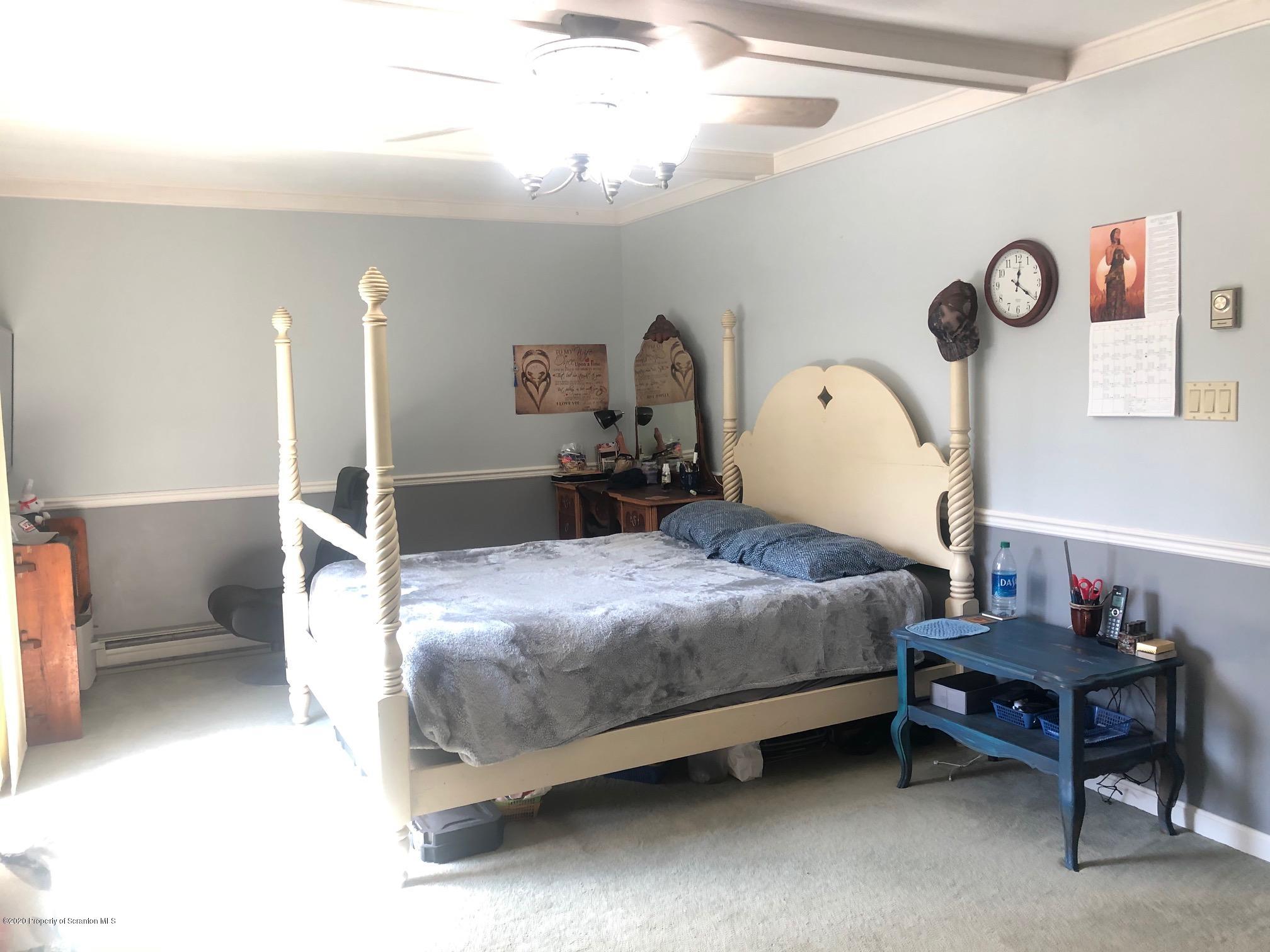 164 Halstead Road Union Dale, PA 18470 - Photo 10 of 36 a bedroom with a bed and a chandelier