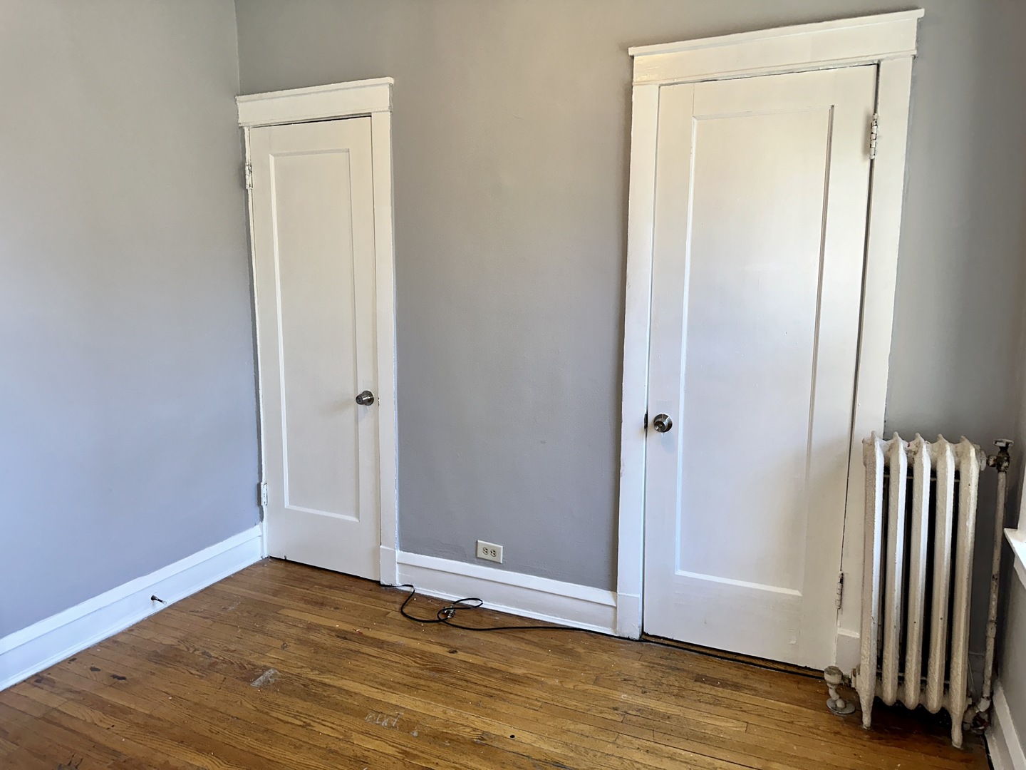 2207 East 67th Street, Unit 2 Chicago, IL 60649 - Photo 11 of 13 an empty room with wooden floor and closet