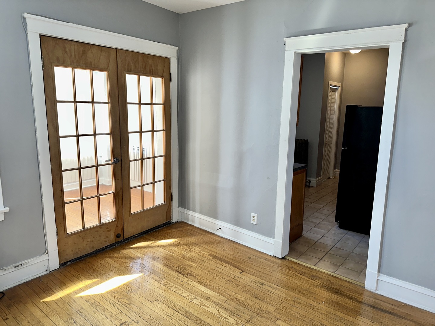 2207 East 67th Street, Unit 2 Chicago, IL 60649 - Photo 7 of 13 an empty room with wooden floor and windows