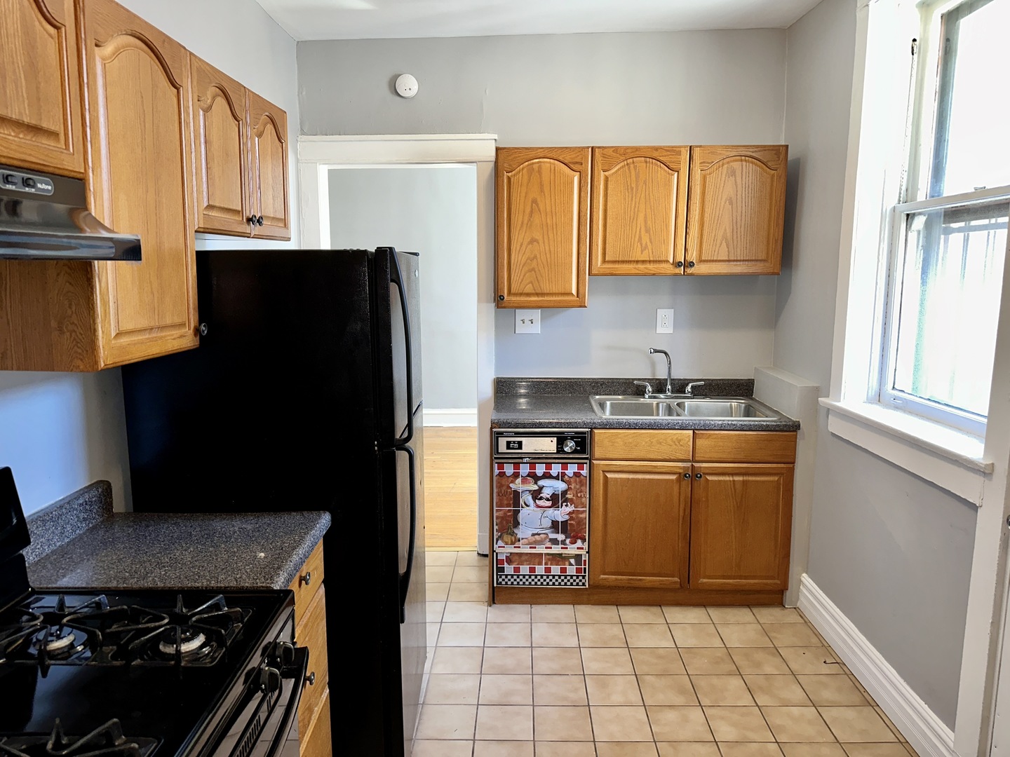 2207 East 67th Street, Unit 2 Chicago, IL 60649 - Photo 10 of 13 a kitchen with stainless steel appliances granite countertop a refrigerator and a stove top oven