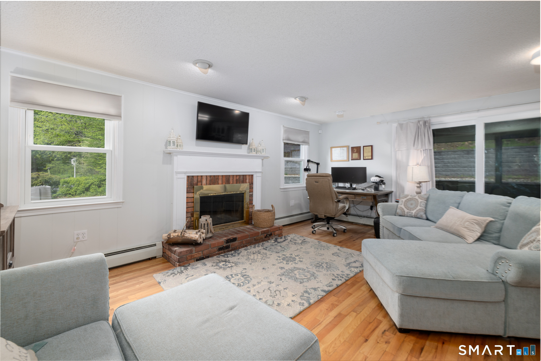 14 Crosswood Road Farmington, CT 06085 - Photo 12 of 39 a living room with furniture a flat screen tv and a fireplace