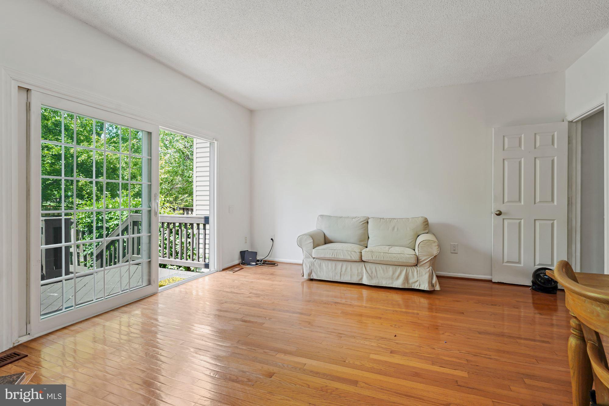 7204 Stover Drive Alexandria, VA 22306 - Photo 6 of 27 Large living room leading out to patio