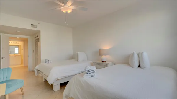 a bedroom with a bed and a lamp