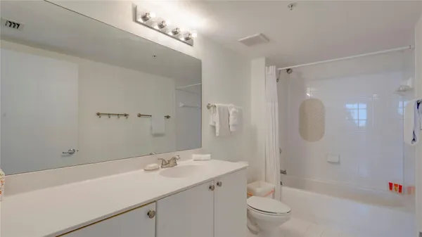 a en suite bathroom with a sink and a mirror