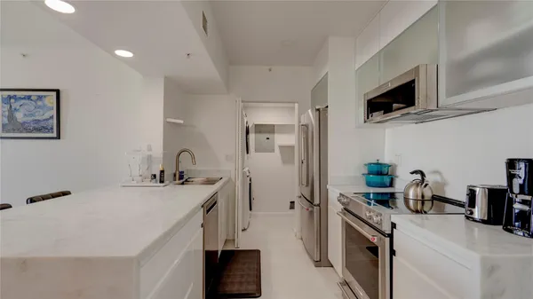 a kitchen that has a sink and a stove top oven