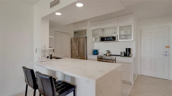 a kitchen with a table and chairs