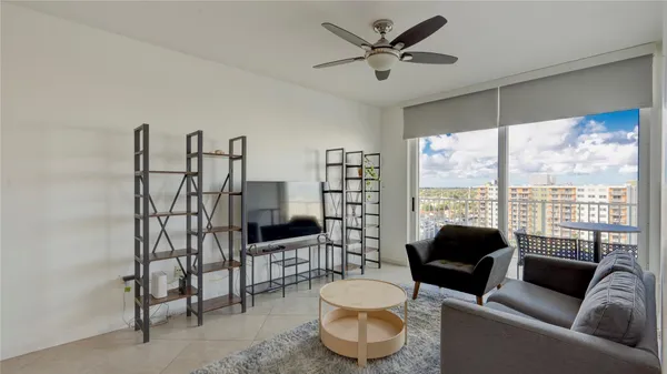 a living room with furniture and a floor to ceiling window