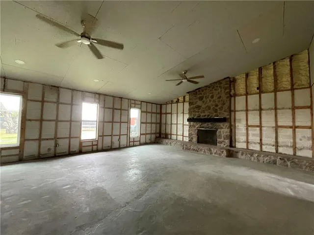 a view of a livingroom with a fireplace and window