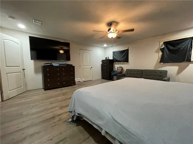 a bedroom with a bed and a television