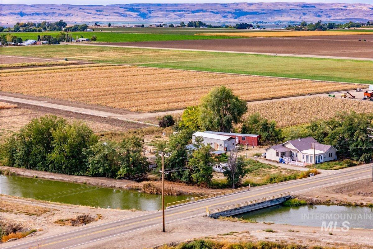 19241 West Homedale Road Caldwell, ID 83607 - Photo 9 of 18 Aerial view of sparsely populated area with large plots for crops and a nearby body of water