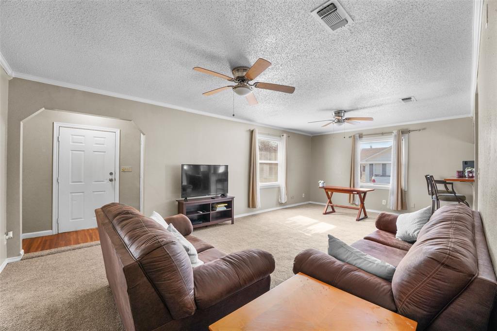 1145 Jefferson Road Paris, TX 75460 - Photo 6 of 17 a living room with furniture a ceiling fan and a rug