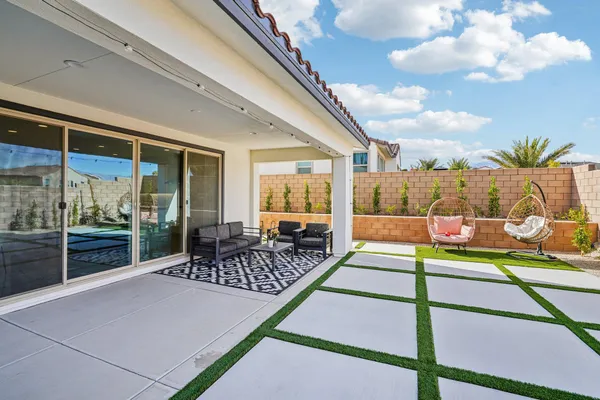 a view of a swimming pool with a patio and fire pit